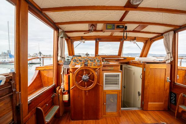 1939 Stephens Brothers Bridgedeck Cruiser interior with wooden helm and classic design.