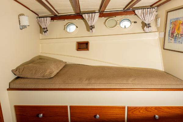 1939 Stephens Brothers Bridgedeck Cruiser cabin interior with bed and portholes.
