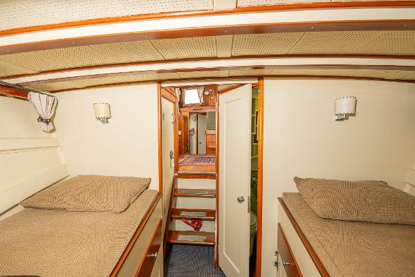 Interior of 1939 Stephens Brothers Bridgedeck Cruiser with twin beds and wooden accents.