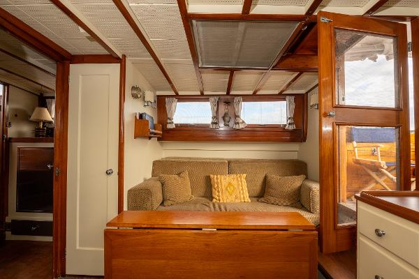 1939 Stephens Brothers Bridgedeck Cruiser interior with cozy seating and wooden accents.