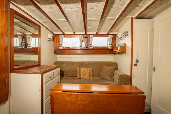 Interior of 1939 Stephens Brothers Bridgedeck Cruiser with cozy seating and wooden accents.