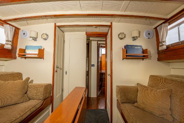 Interior of 1939 Stephens Brothers Bridgedeck Cruiser with cozy seating and wooden accents.