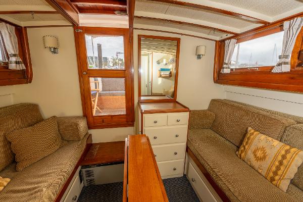 Interior of 1939 Stephens Brothers Bridgedeck Cruiser with cozy seating and wooden accents.