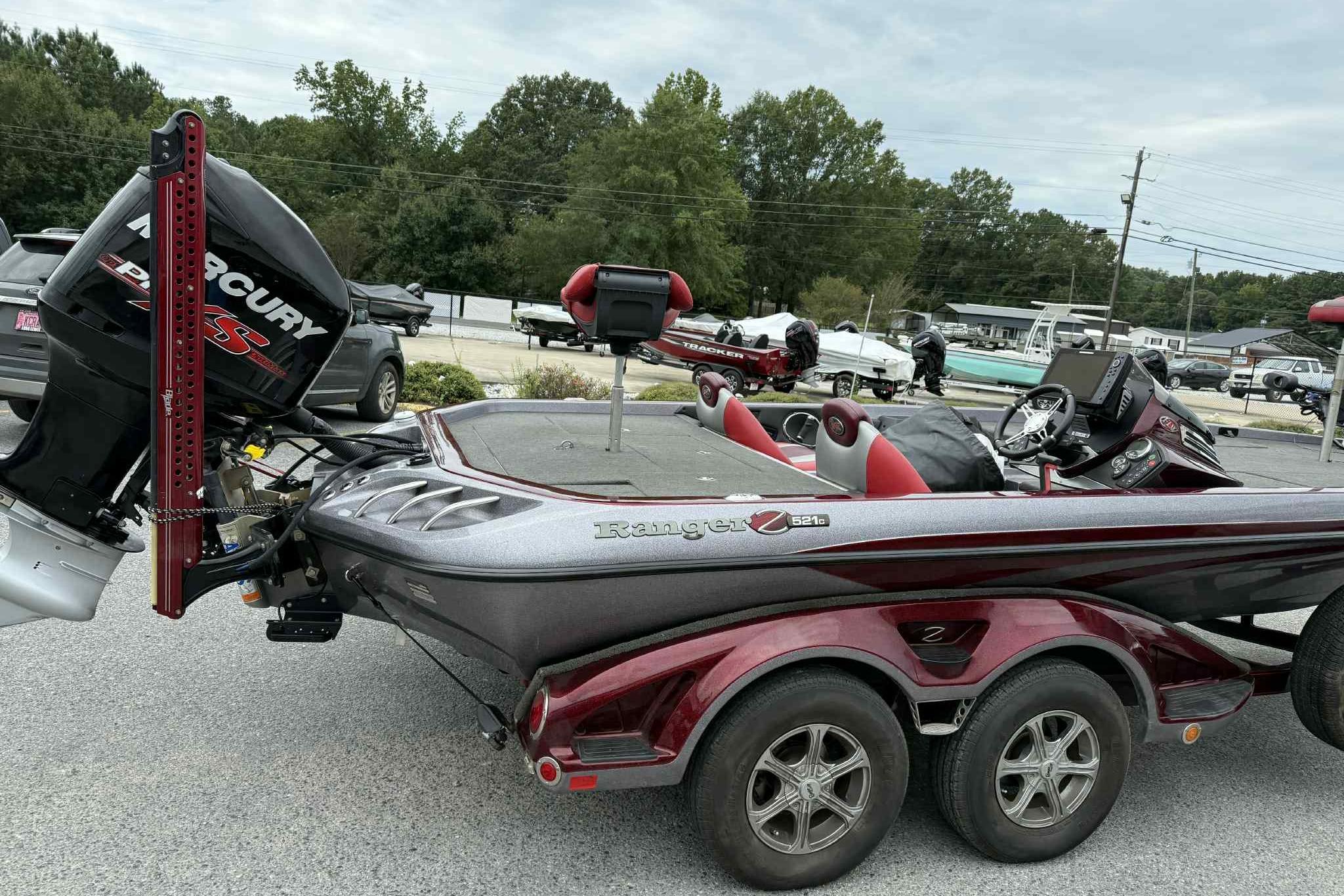2014 Ranger Z521 Comanche boat with Mercury engine, parked outdoors.