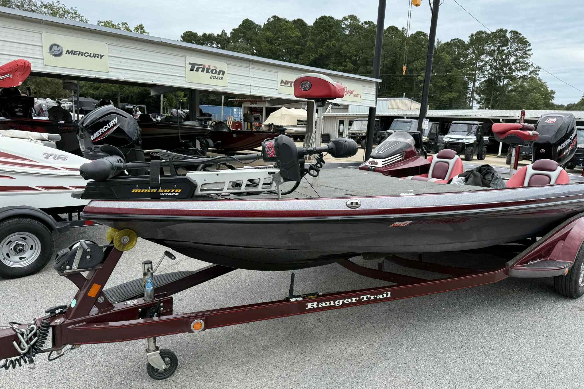 2014 Ranger Z521 Comanche boat on trailer at dealership, featuring Mercury engine.