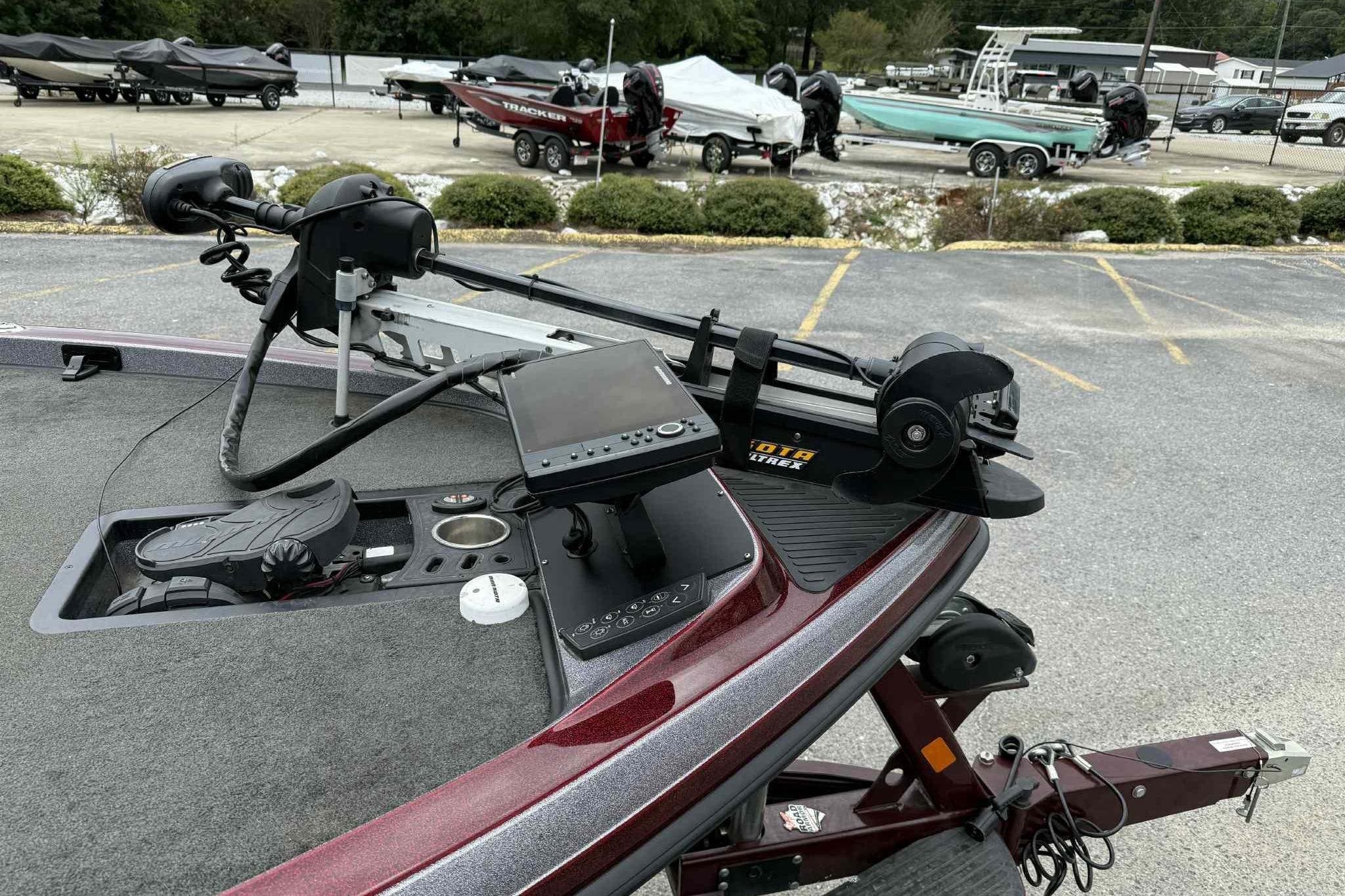 2014 Ranger Z521 Comanche boat with advanced navigation equipment in a parking lot.