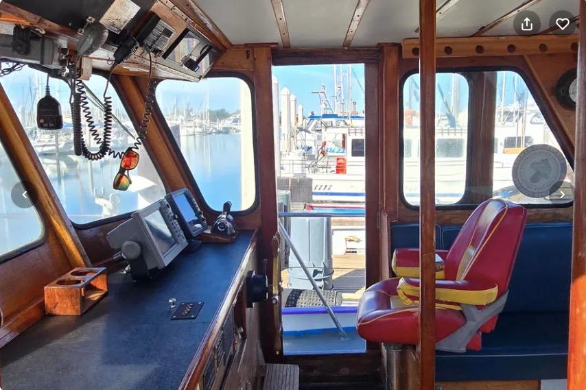 1978 Uniflite 50 boat interior with control panel and red captain's chair.