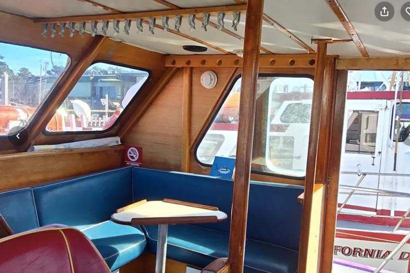 1978 Uniflite 50 boat interior with blue seating and wooden accents.