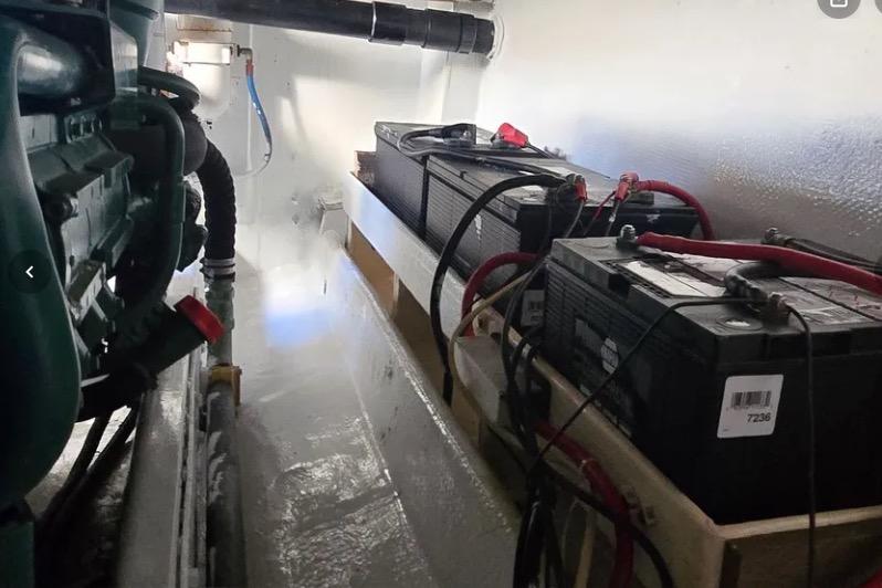 Engine room of a 1978 Uniflite 50 with batteries and wiring.