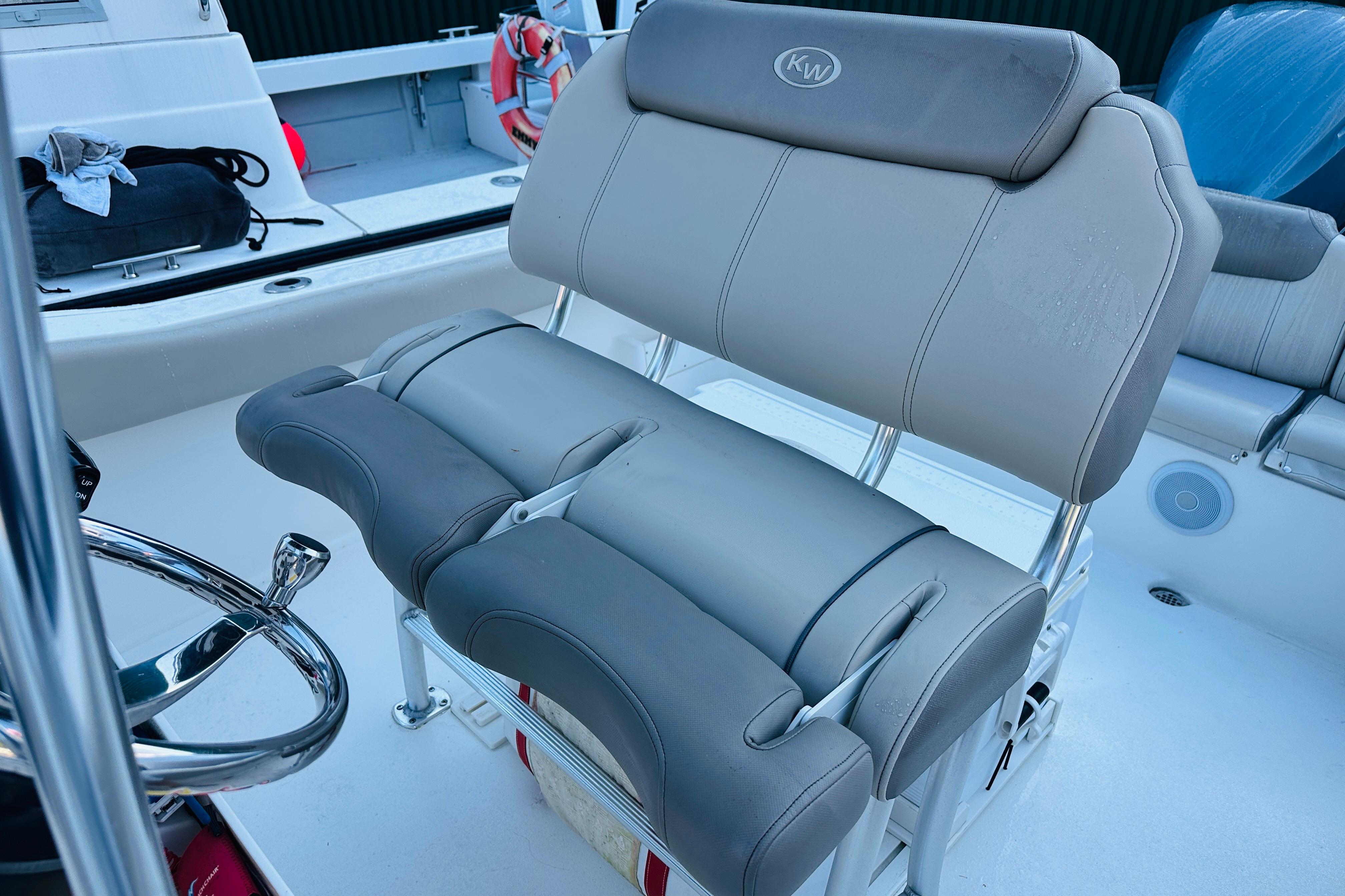 2022 Key West 239 FS boat with cushioned seating and steering wheel.