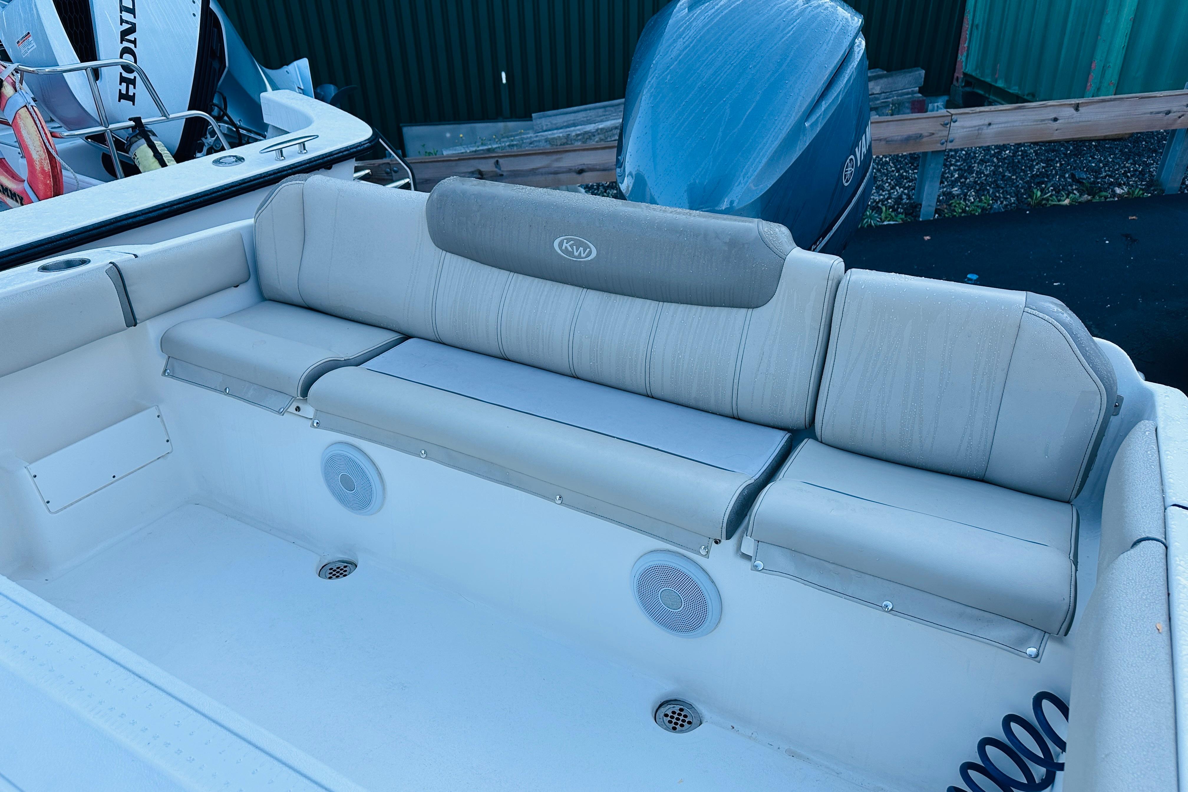 2022 Key West 239 FS boat interior with cushioned seating and speakers.
