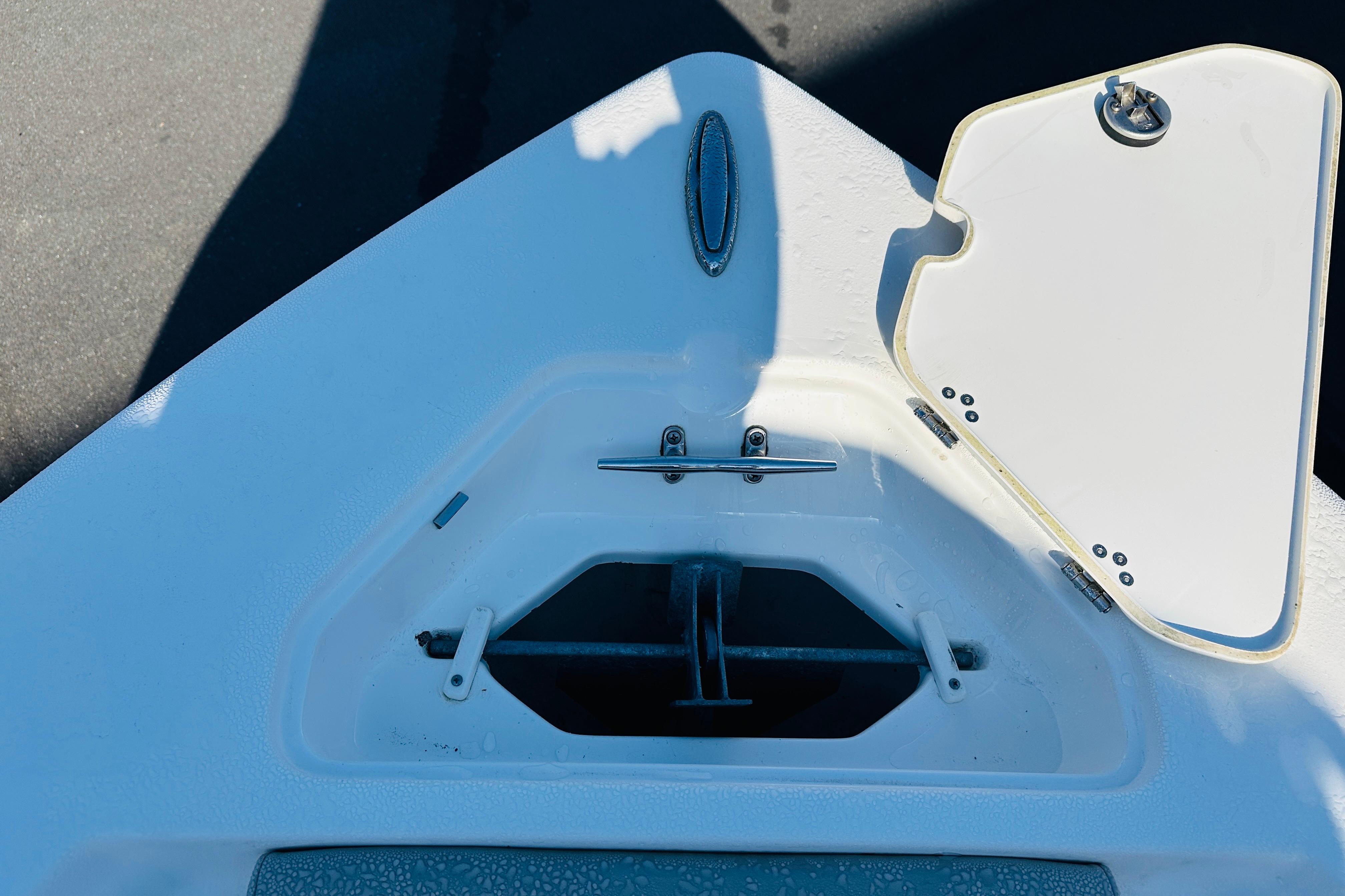 Bow anchor compartment of 2022 Key West 239 FS boat, featuring open hatch and cleat.