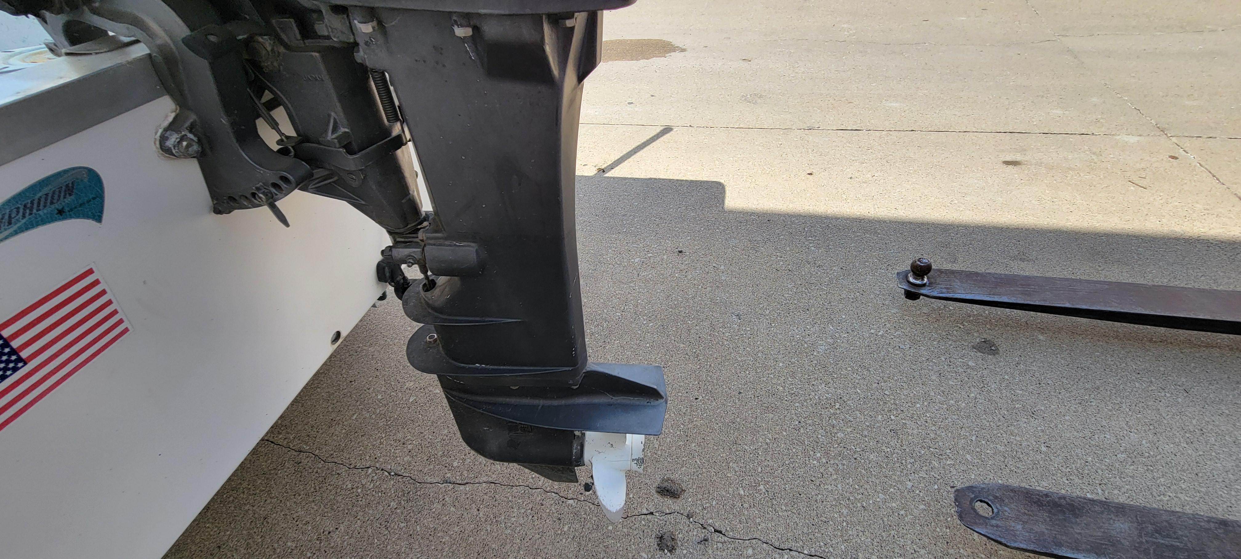 1996 Tracker Pro Angler V 16 boat motor and propeller on concrete surface.
