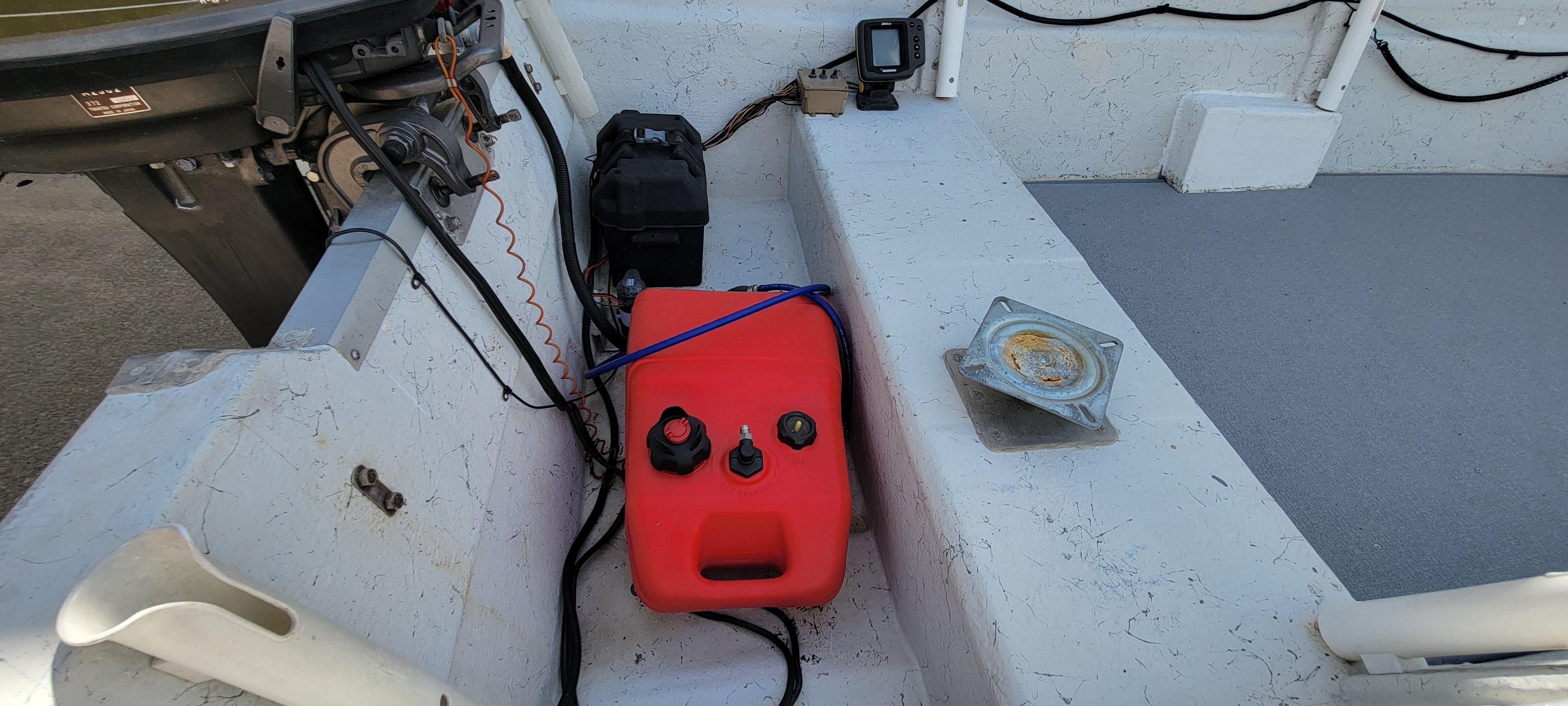 1996 Tracker Pro Angler V 16 boat interior with red fuel tank and motor.