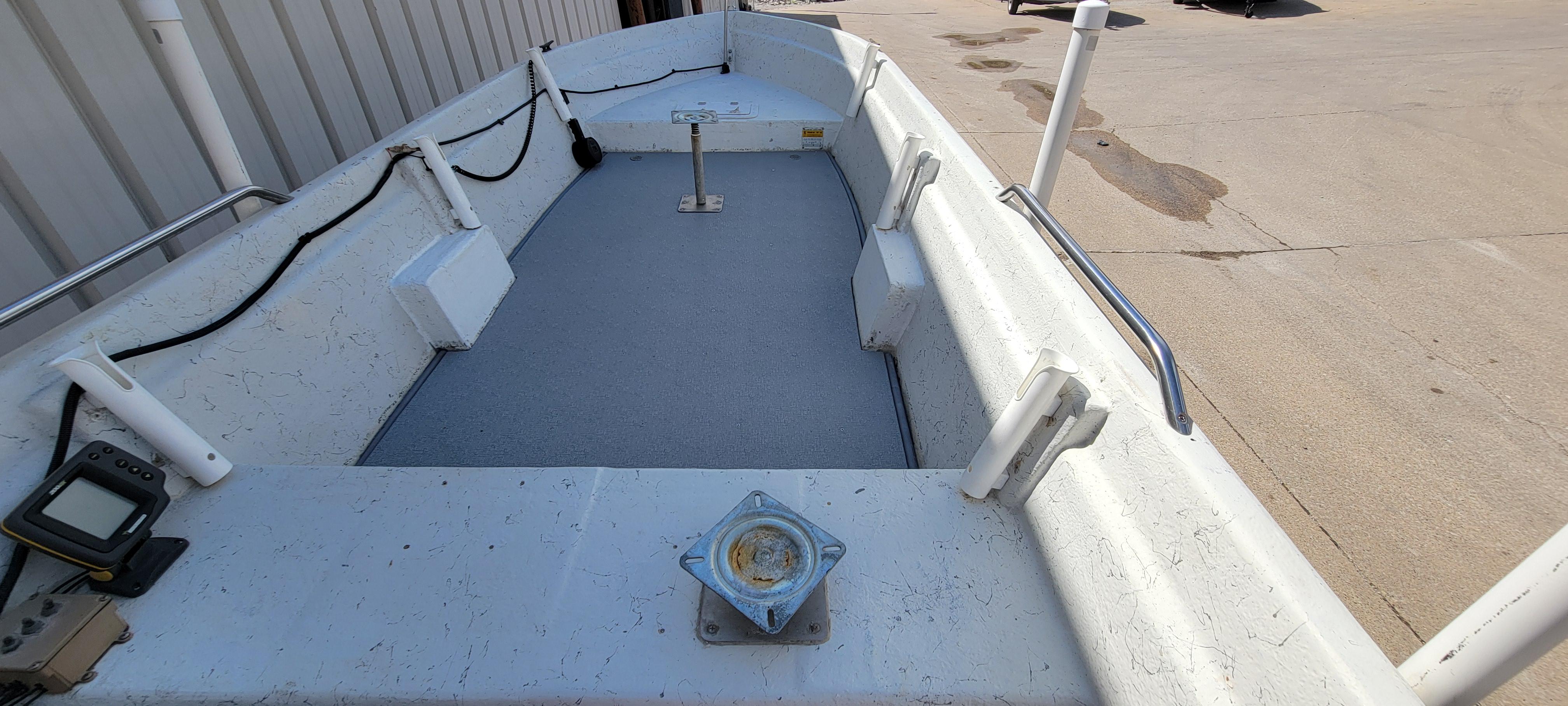 1996 Tracker Pro Angler V 16 boat interior with fishing equipment and seating.