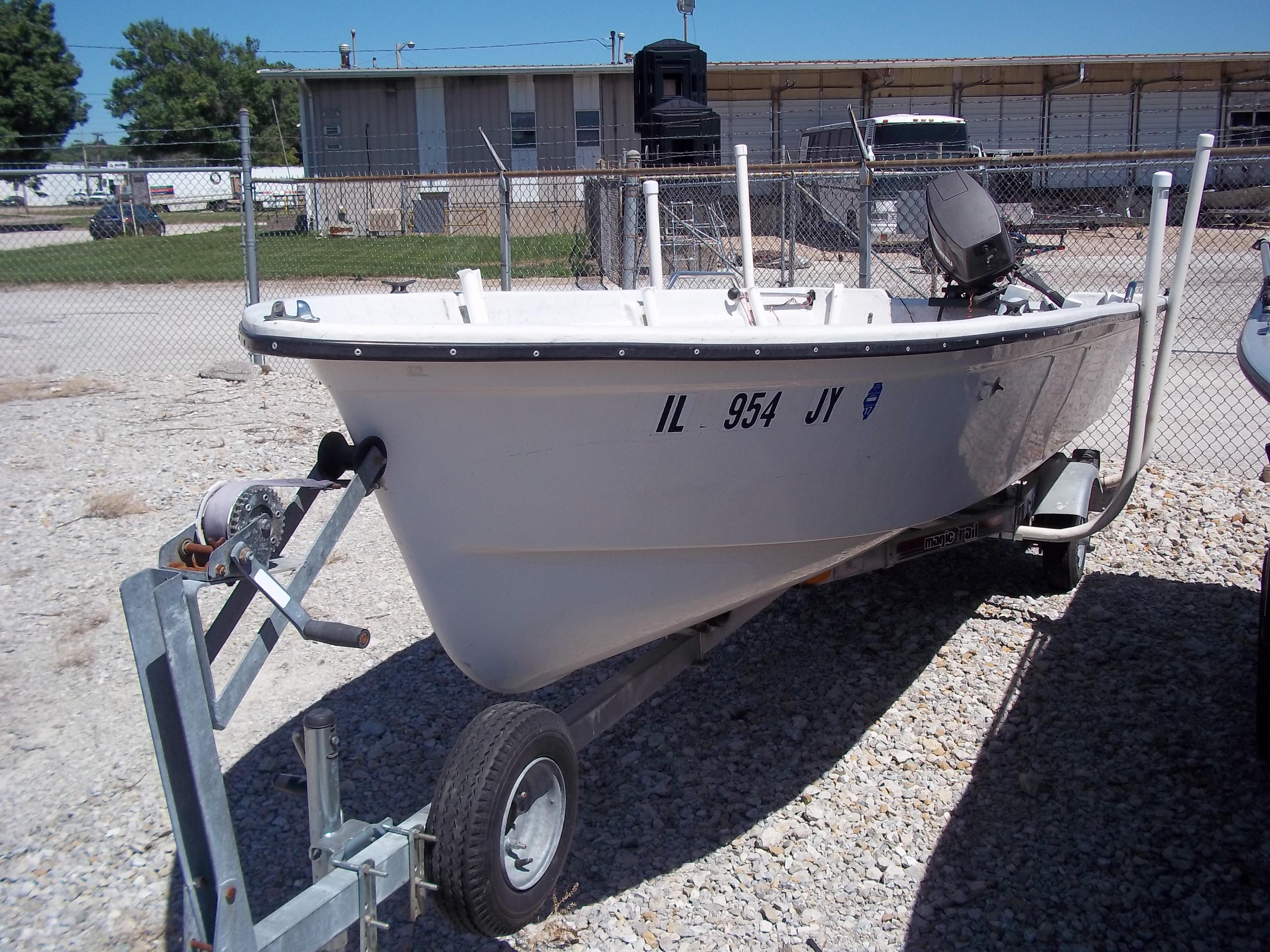 1996 Tracker Pro Angler V 16 boat on trailer, parked in gravel lot.
