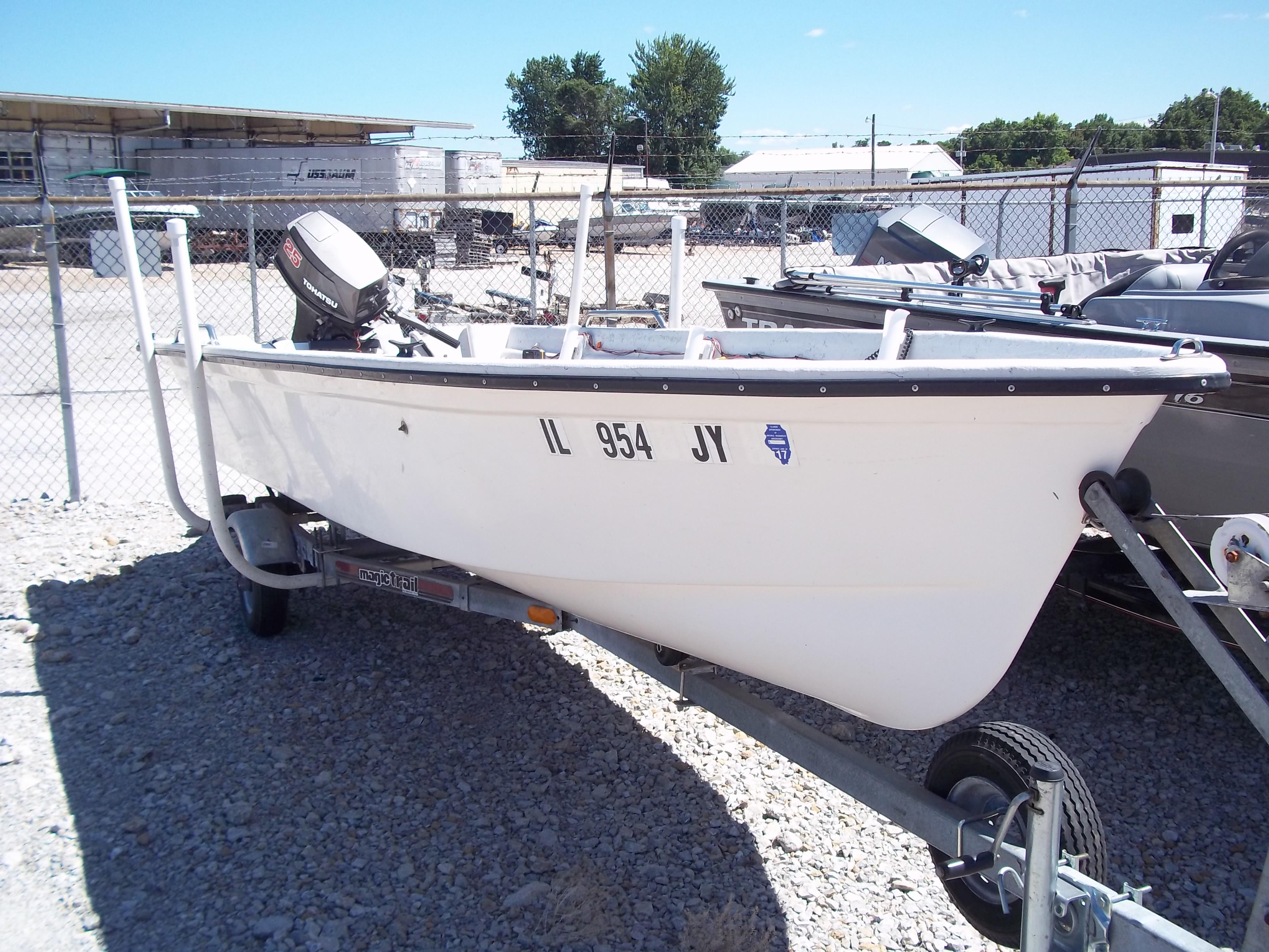 1996 Tracker Pro Angler V 16 boat on trailer, parked in a gravel lot.