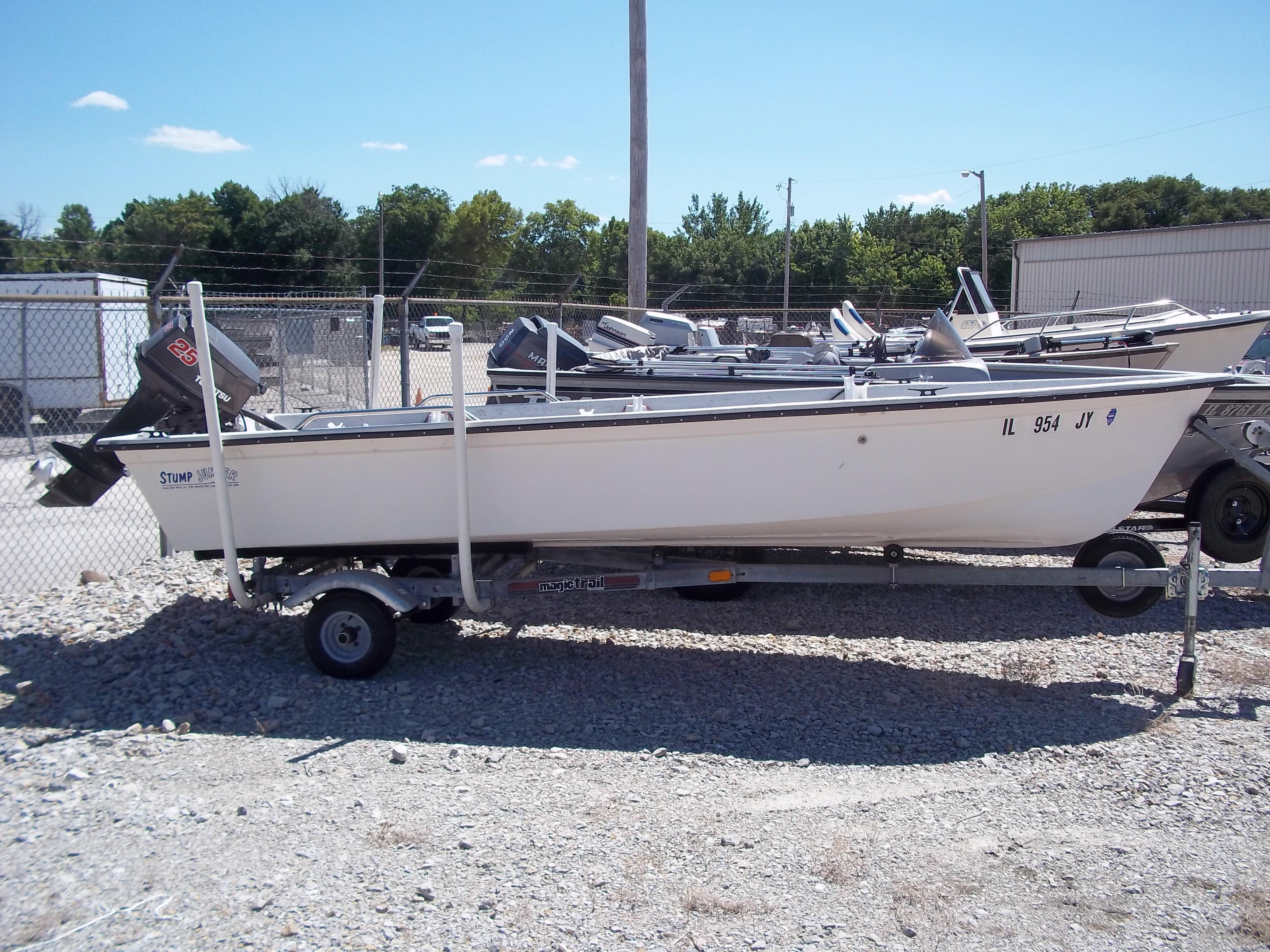 1996 Tracker Pro Angler V 16 boat on trailer, parked on gravel lot.