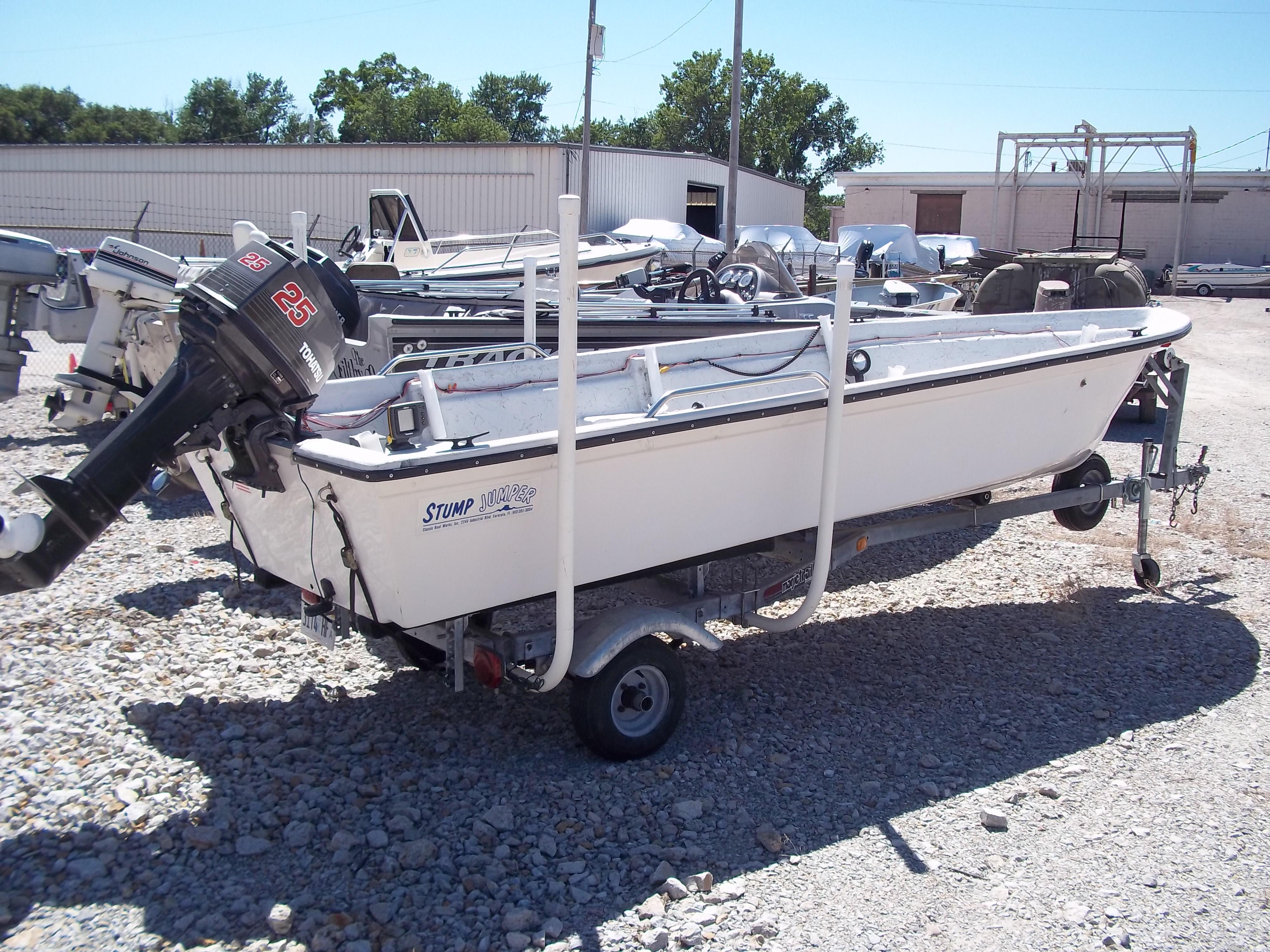 1996 Tracker Pro Angler V 16 boat on trailer in outdoor storage area.