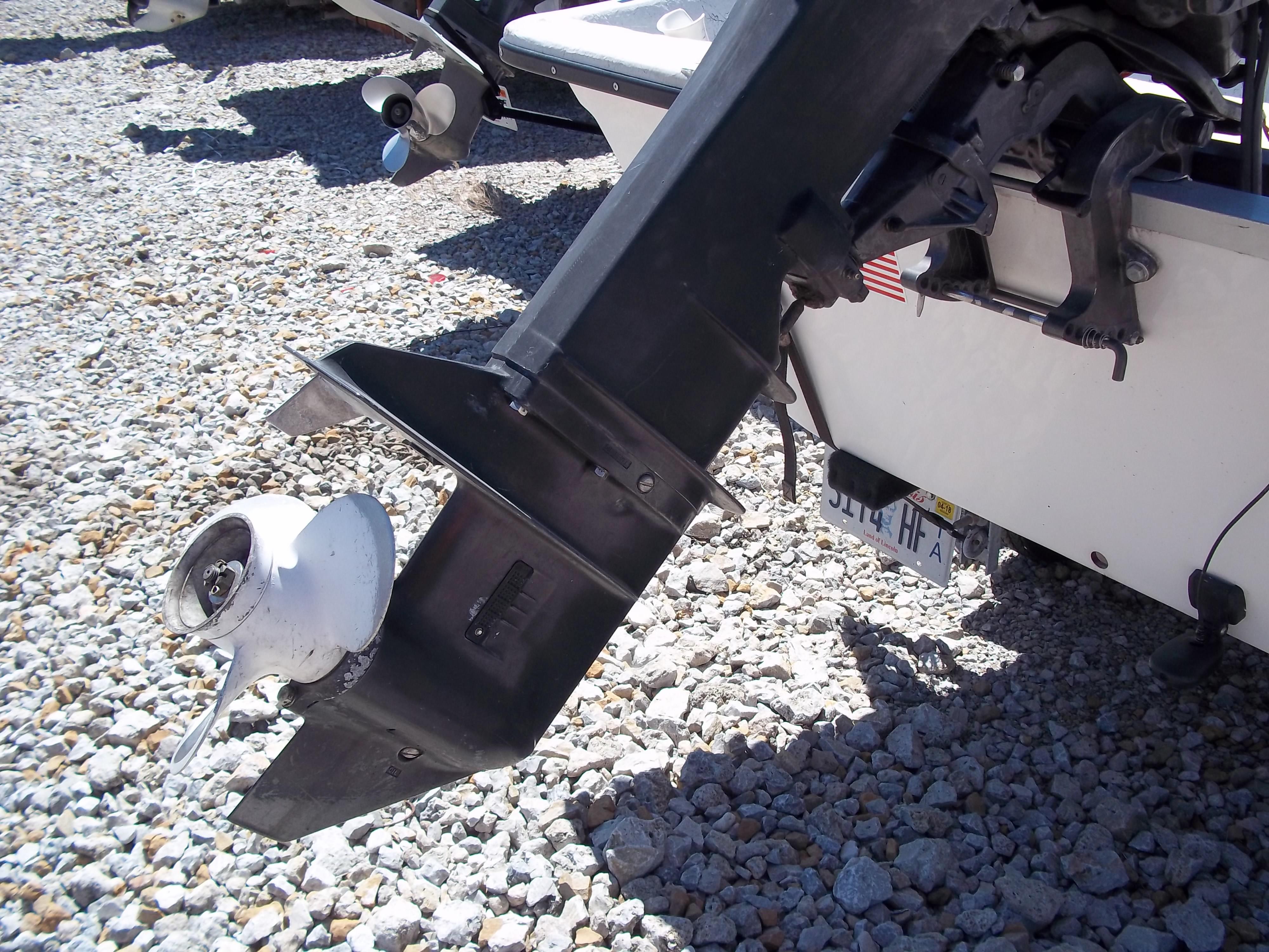 1996 Tracker Pro Angler V 16 boat motor on gravel surface.