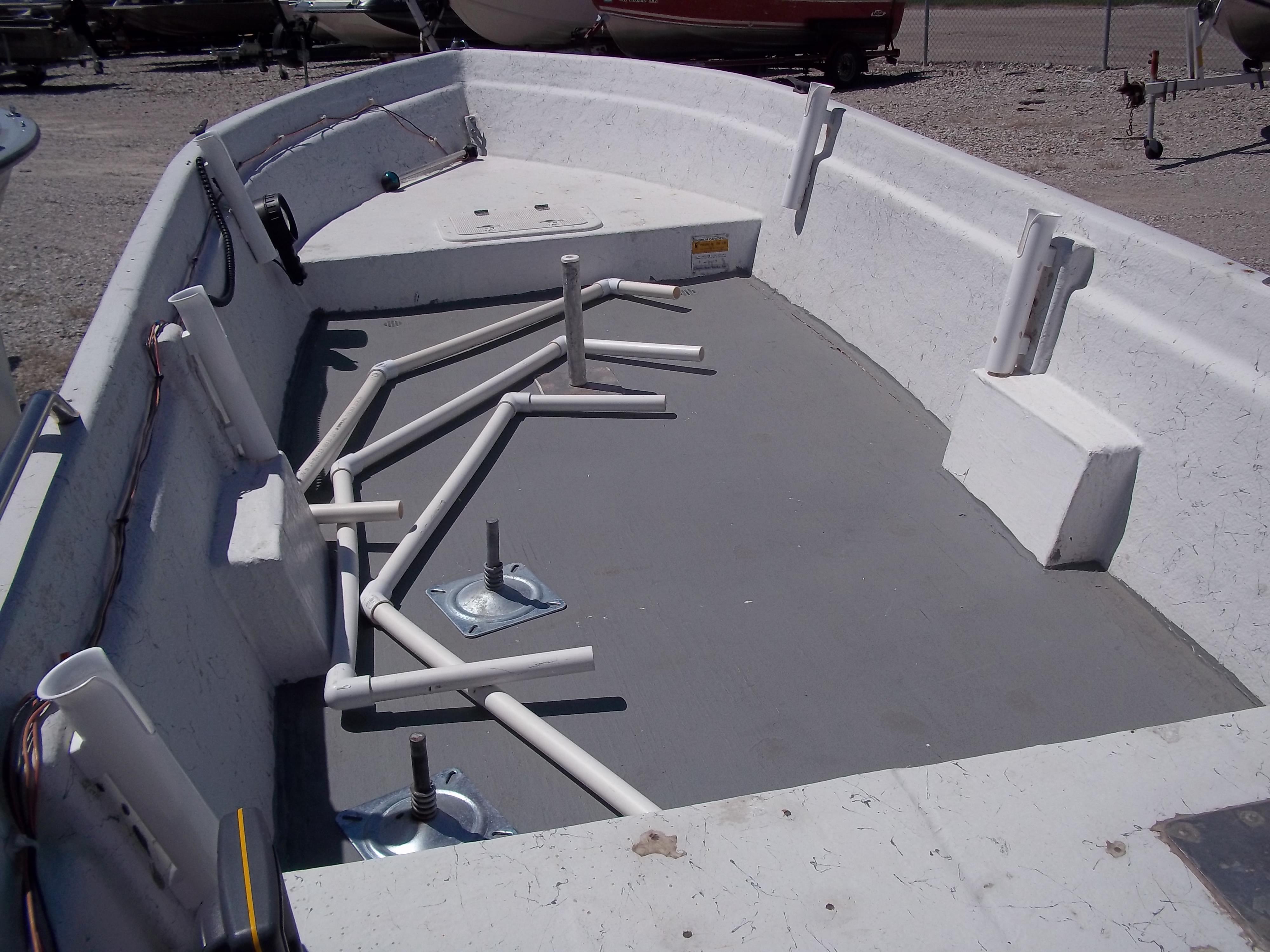 1996 Tracker Pro Angler V 16 boat interior with rod holders and storage compartments.