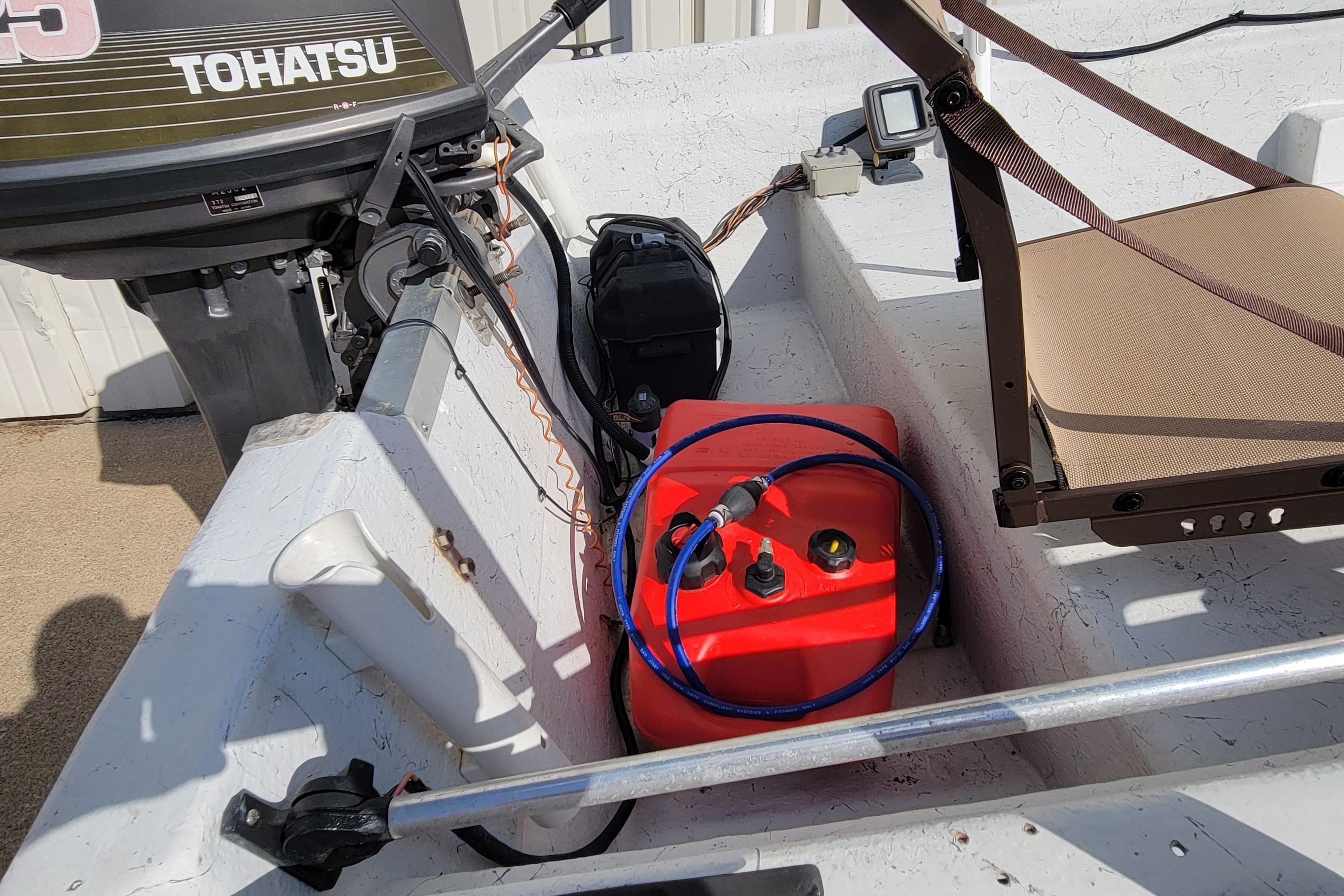 1996 DILKES STUMP JUMPER boat with Tohatsu motor and red fuel tank.