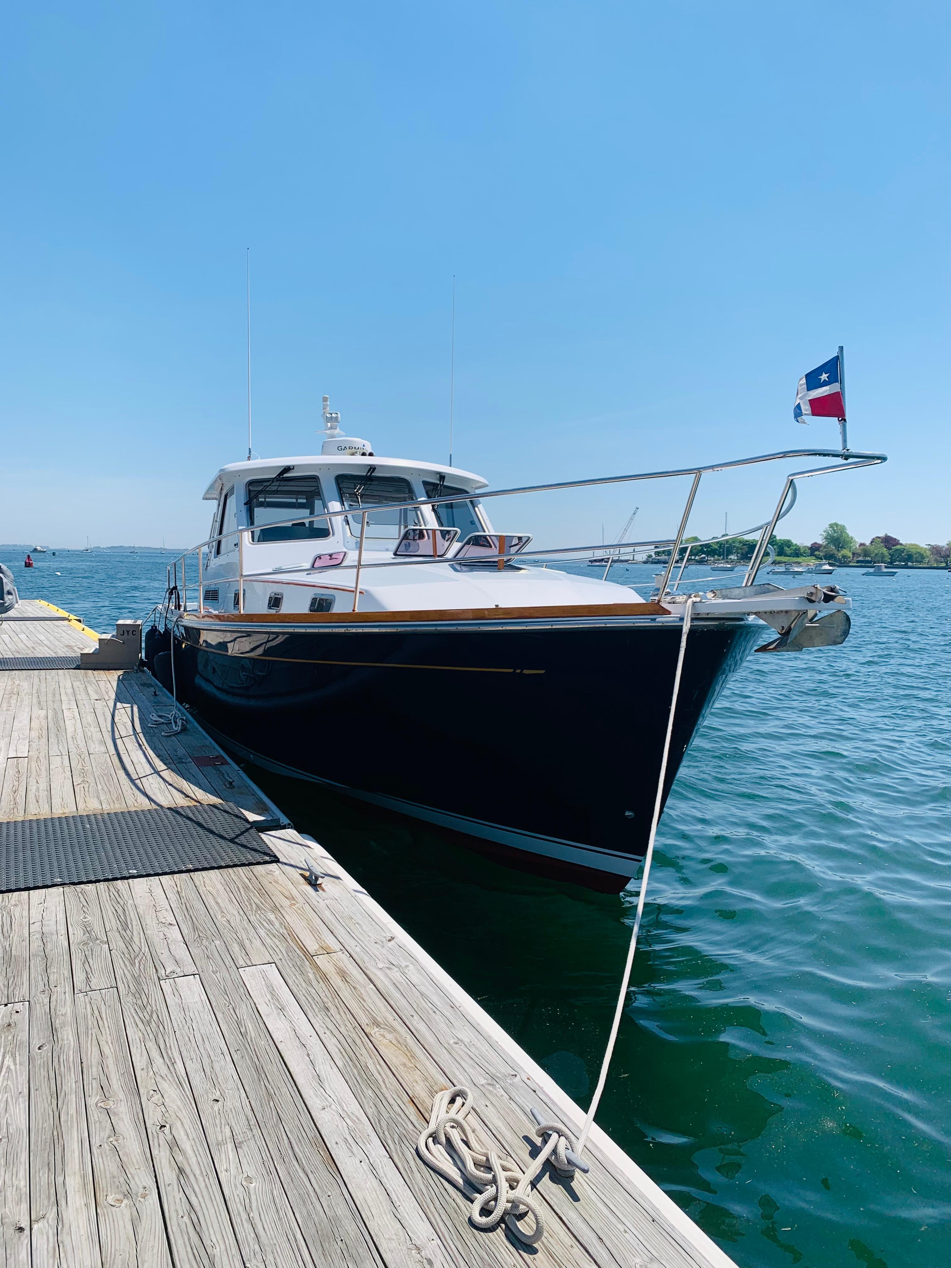 2004 Sabre 42 Hardtop Express yacht docked on a sunny day.