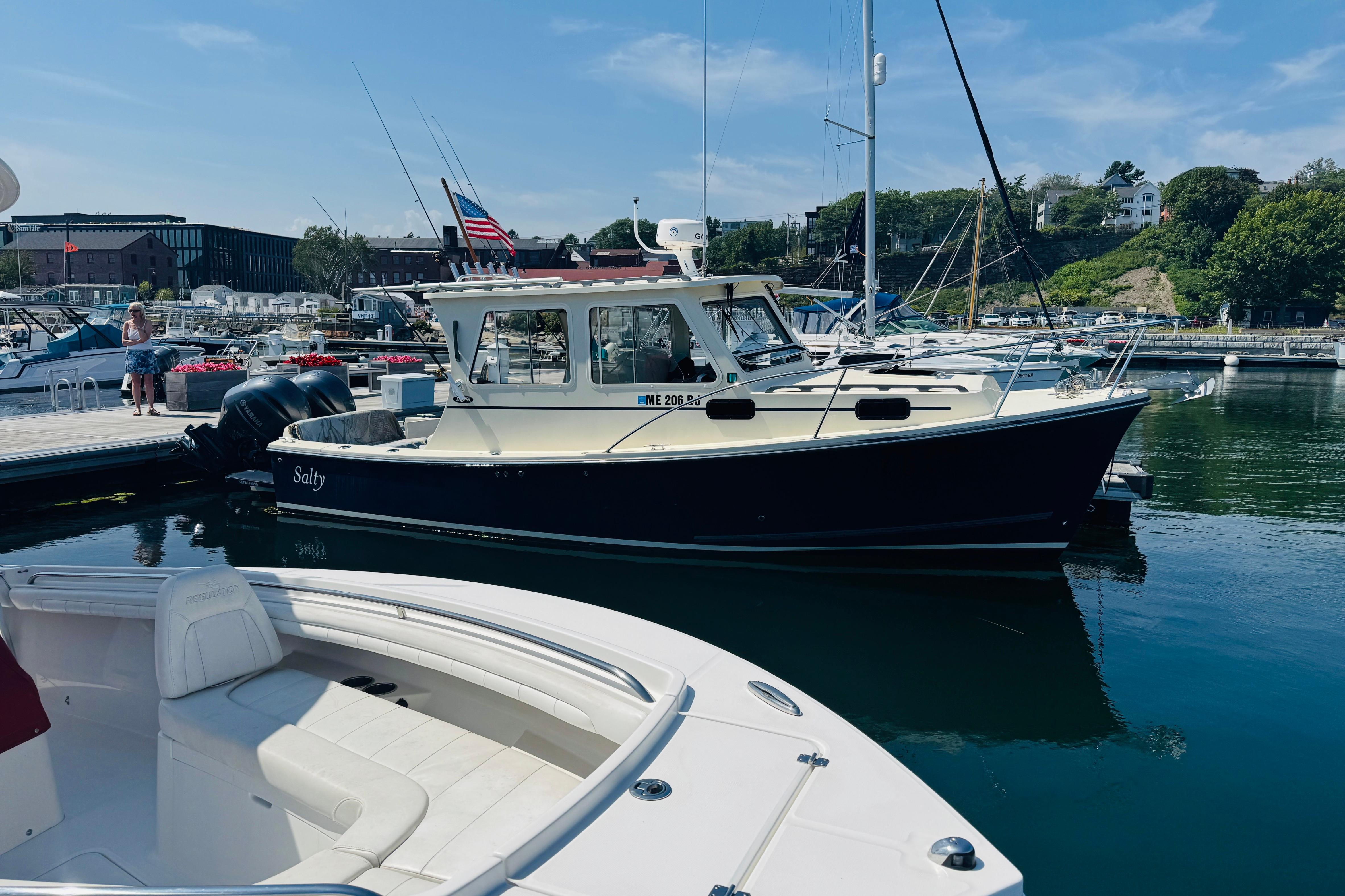 2015 Eastern 270 Islander boat docked in a marina with clear skies.