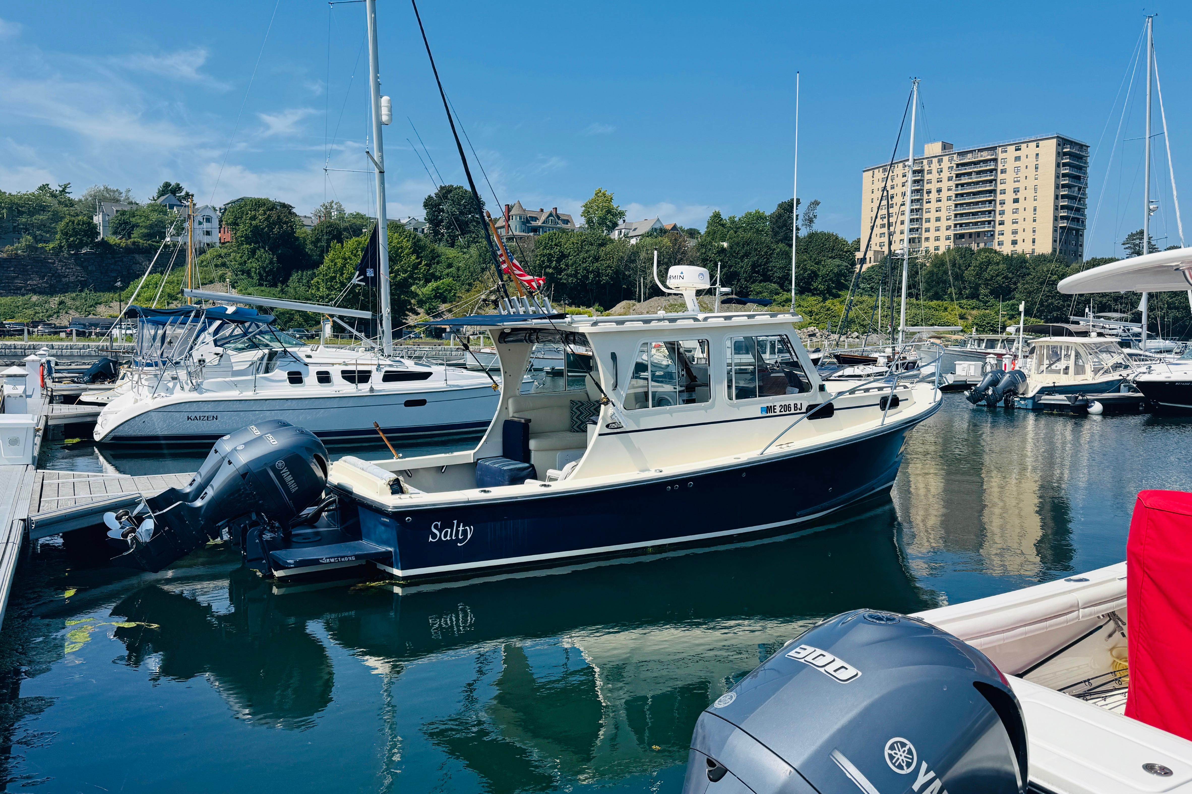 2015 Eastern 270 Islander boat docked in a marina with scenic background.