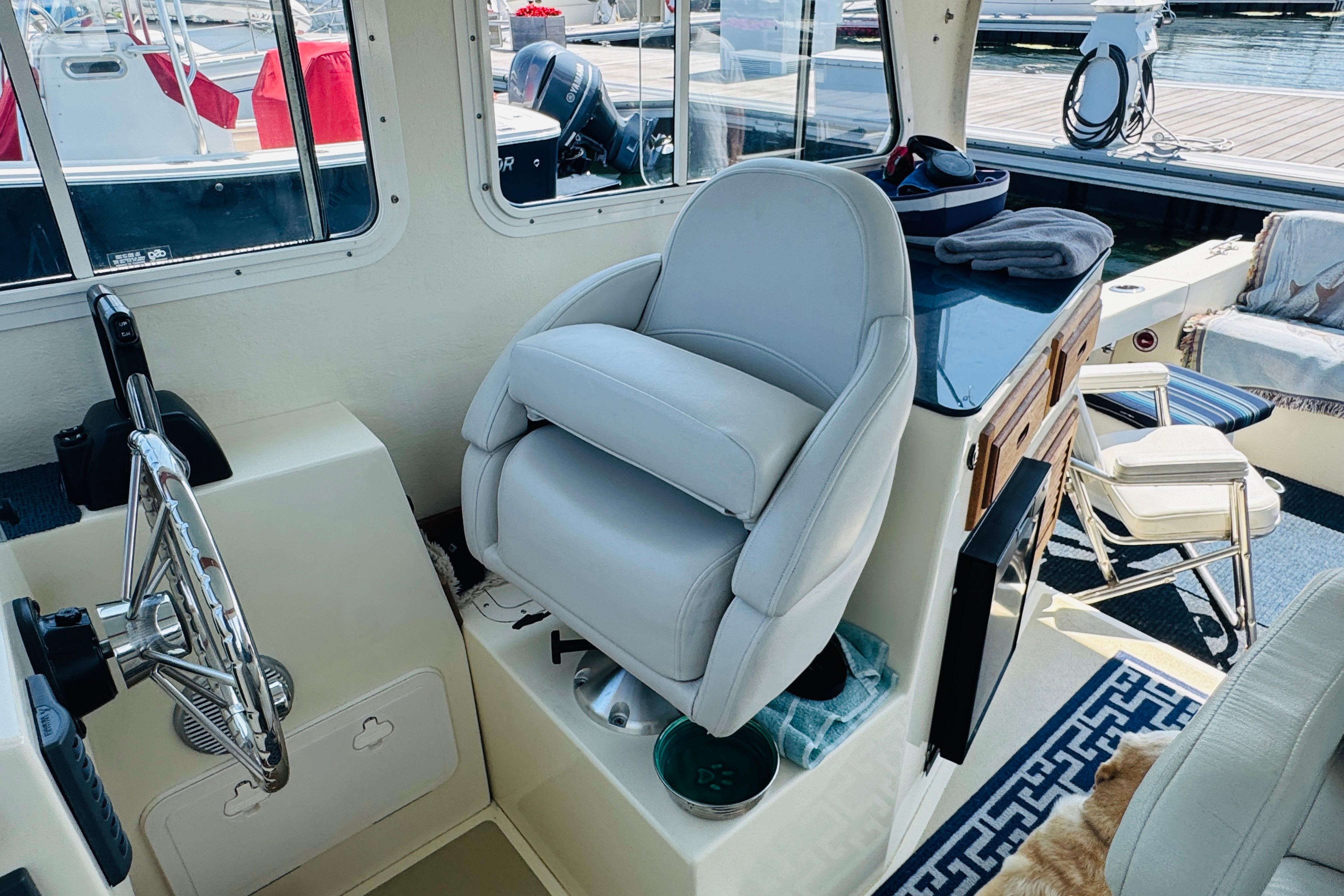 Interior of a 2015 Eastern 270 Islander boat with helm and seating area.