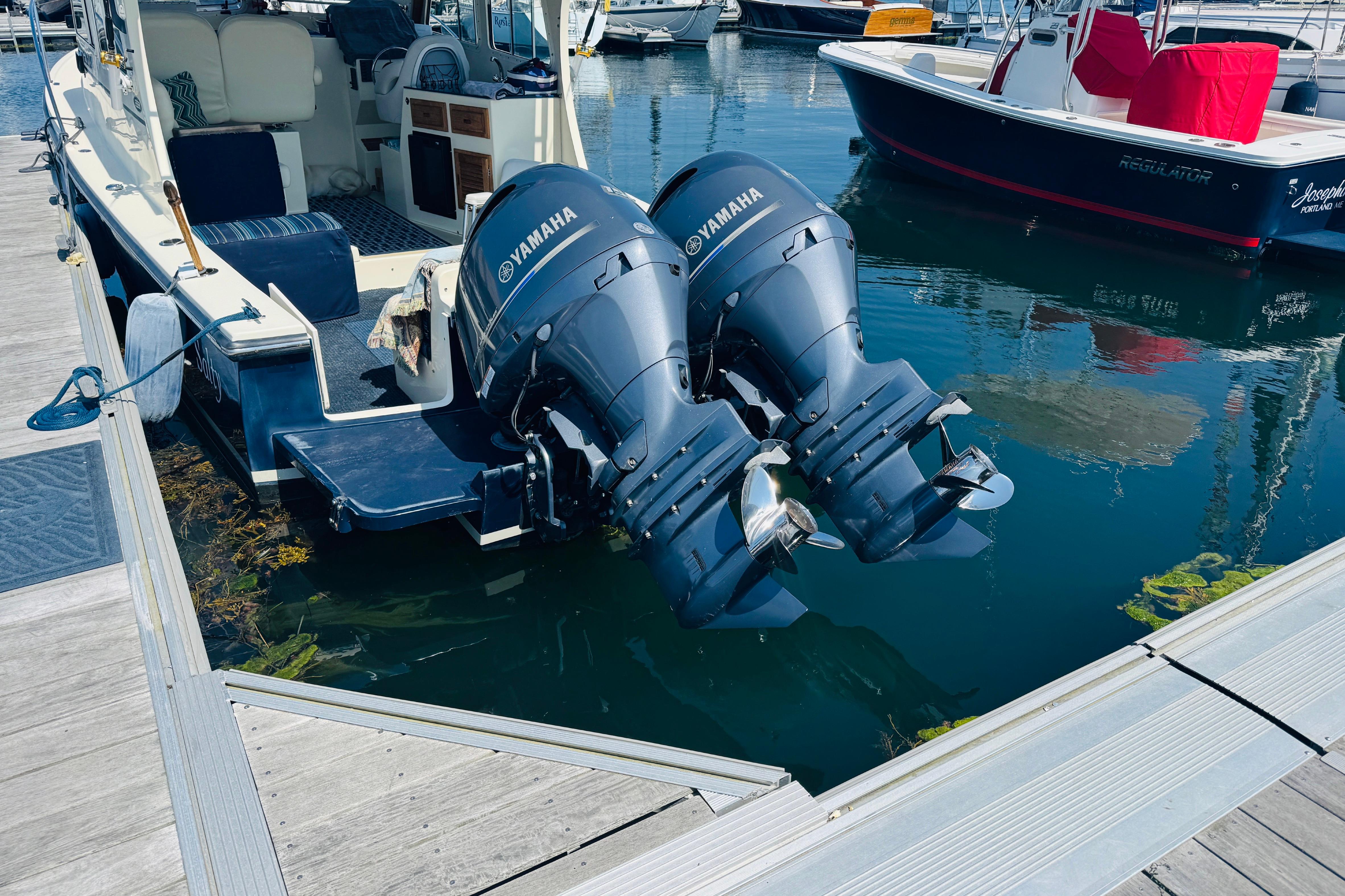 2015 Eastern 270 Islander boat with twin Yamaha outboard motors docked at marina.