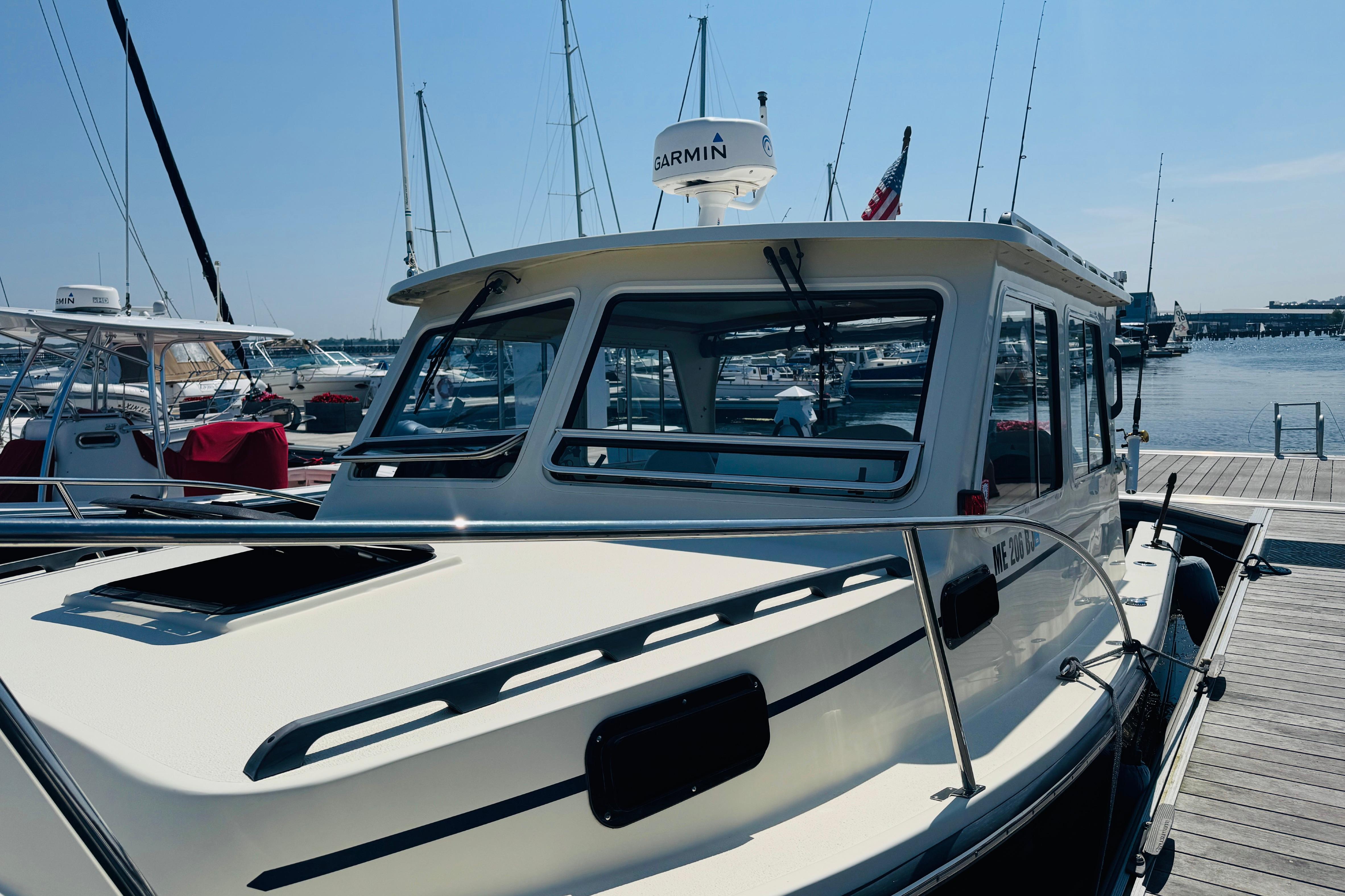 2015 Eastern 270 Islander boat docked at marina, sunny day, clear sky.