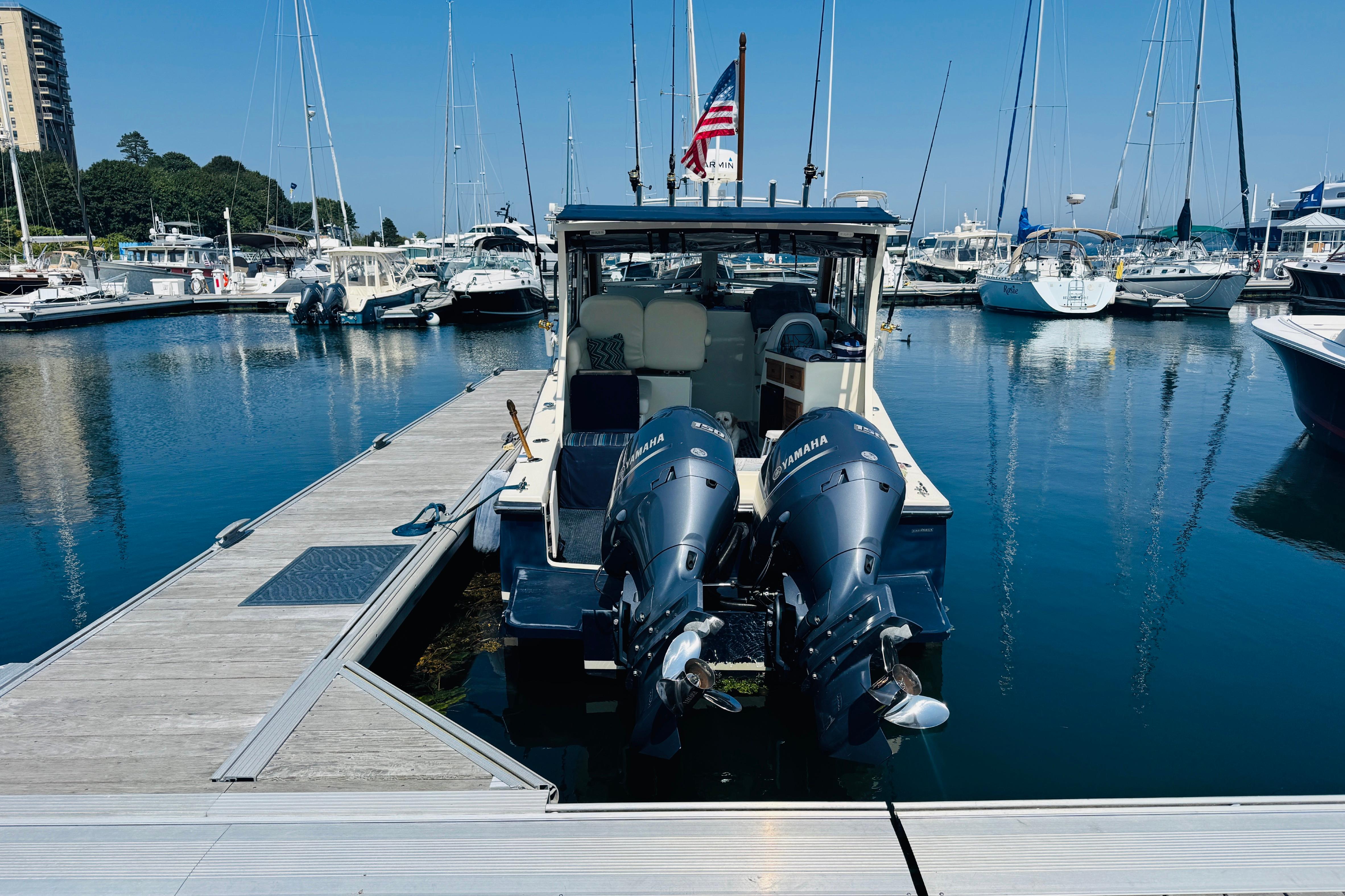 2015 Eastern 270 Islander boat docked at marina with twin Yamaha engines.