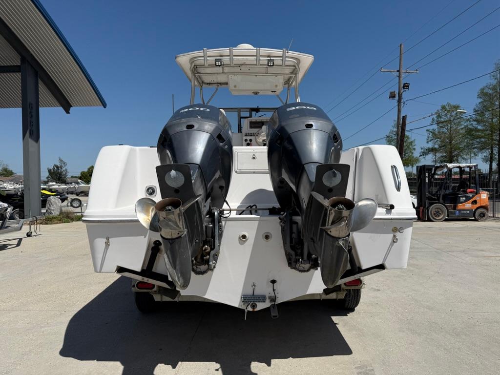 Rear view of 2000 Pro-Line 27 Walk boat with dual outboard motors.