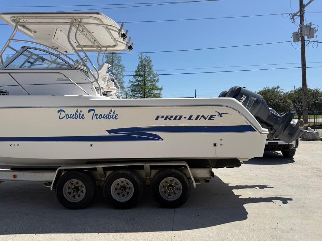 2000 Pro-Line 27 Walk boat on trailer, labeled 