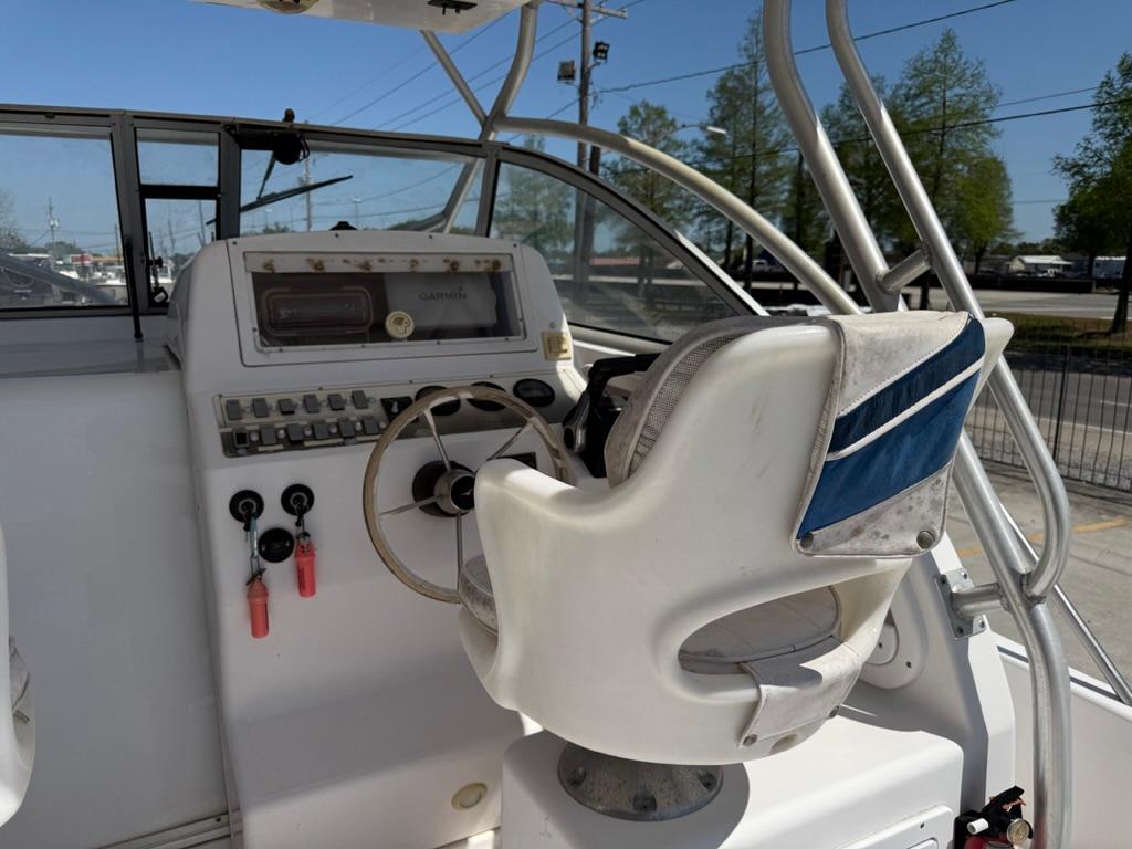 Helm of 2000 Pro-Line 27 Walk boat with steering wheel and control panel.