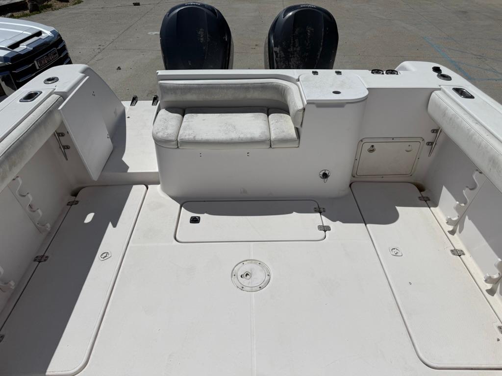 2000 Pro-Line 27 Walk boat deck with seating and dual engines.