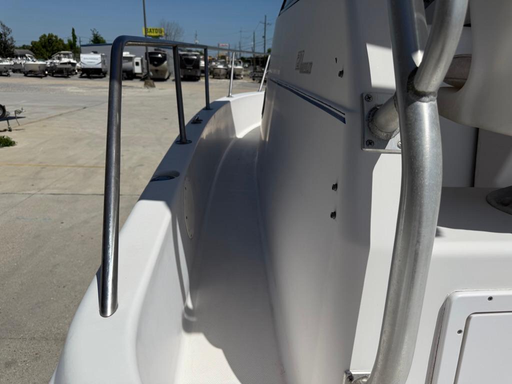 2000 Pro-Line 27 Walk boat side view with railing in a marina setting.