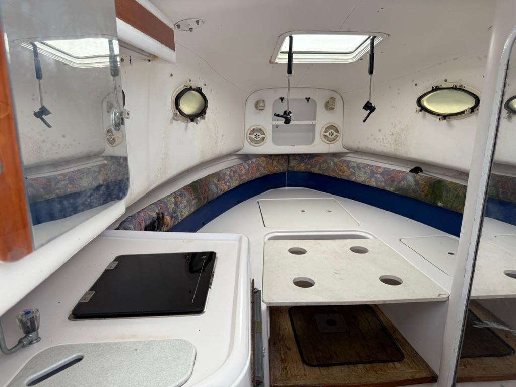 Interior of a 2000 Pro-Line 27 Walk boat, featuring a compact cabin layout.