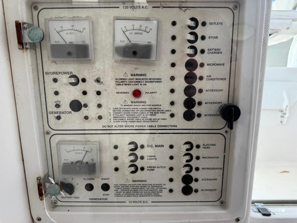 Control panel of a 2000 Pro-Line 27 Walk boat, featuring various electrical switches and gauges.