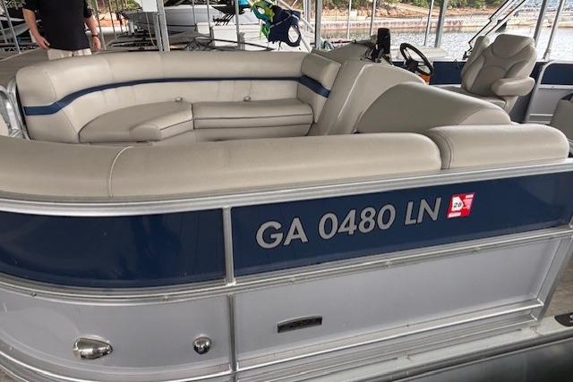 2017 South Bay 222 RS pontoon boat with beige seating, docked in a marina.