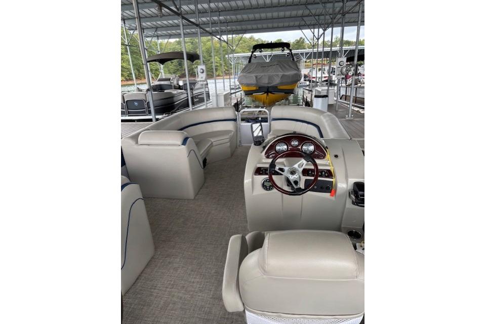 2017 South Bay 222 RS pontoon boat interior with steering wheel and seating.