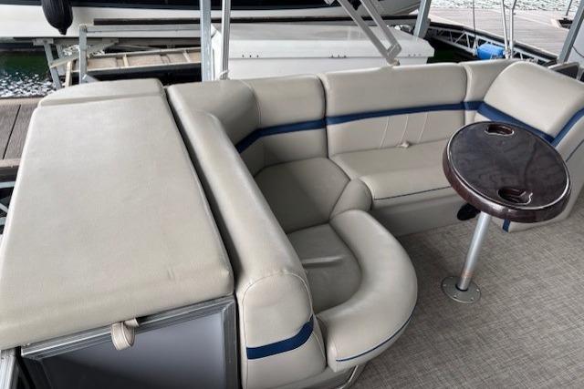 2017 South Bay 222 RS boat interior with beige seating and small round table.