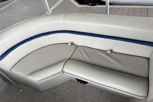 2017 South Bay 222 RS boat interior with beige and blue cushioned seating.