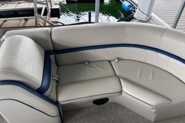 2017 South Bay 222 RS boat interior with white and blue cushioned seating.