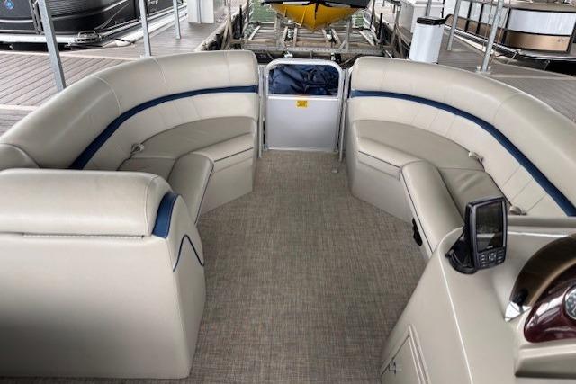2017 South Bay 222 RS pontoon boat interior with beige seating and modern dashboard.