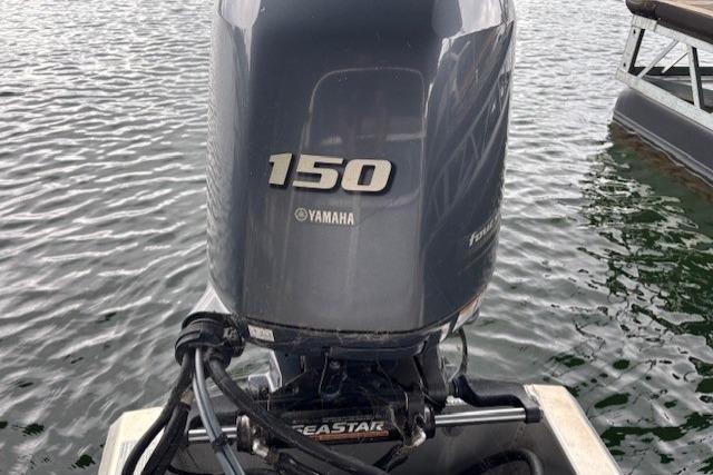 Yamaha 150 outboard motor on 2017 South Bay 222 RS boat, floating on water.