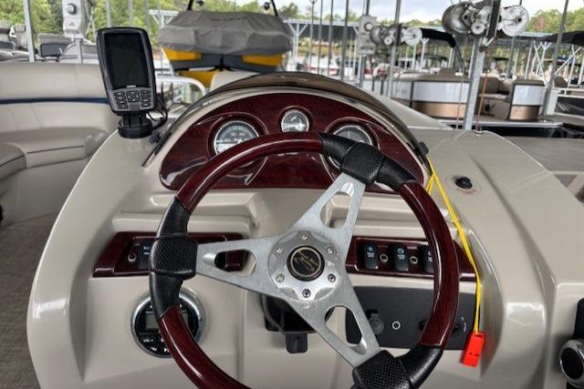 Steering console of 2017 South Bay 222 RS pontoon boat with gauges and GPS device.