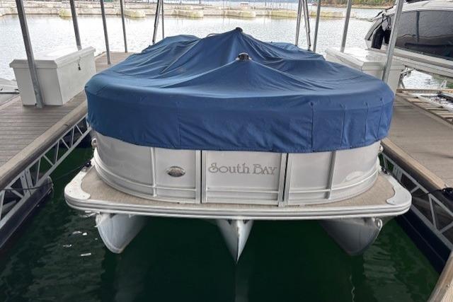2017 South Bay 222 RS pontoon boat with blue cover docked in marina.
