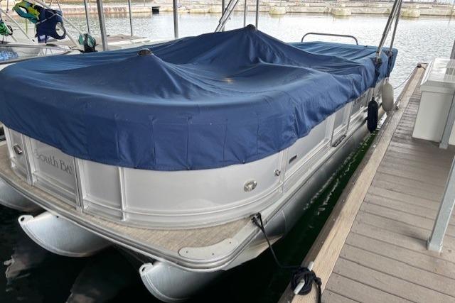 2017 South Bay 222 RS pontoon boat docked with blue cover.